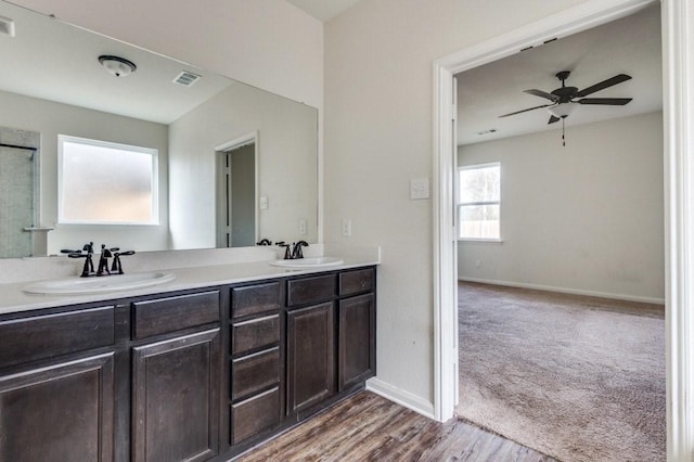 bathroom with ceiling fan, hardwood / wood-style floors, and vanity