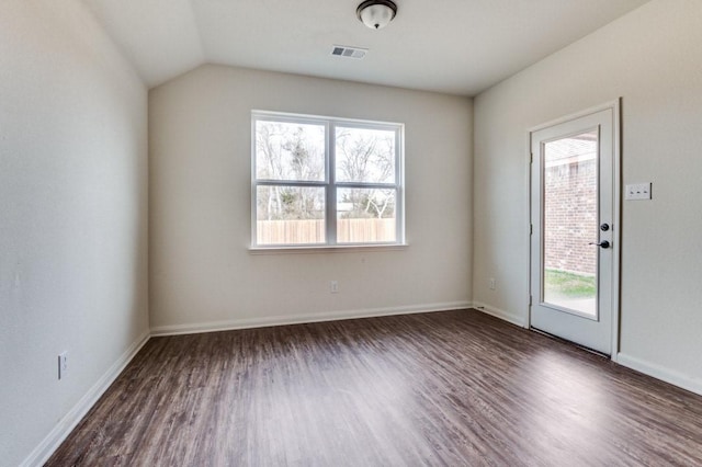 spare room with dark hardwood / wood-style floors and lofted ceiling