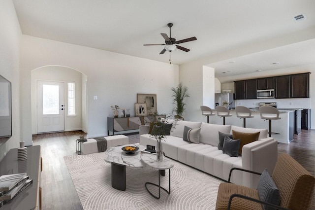 living room with light hardwood / wood-style floors and ceiling fan