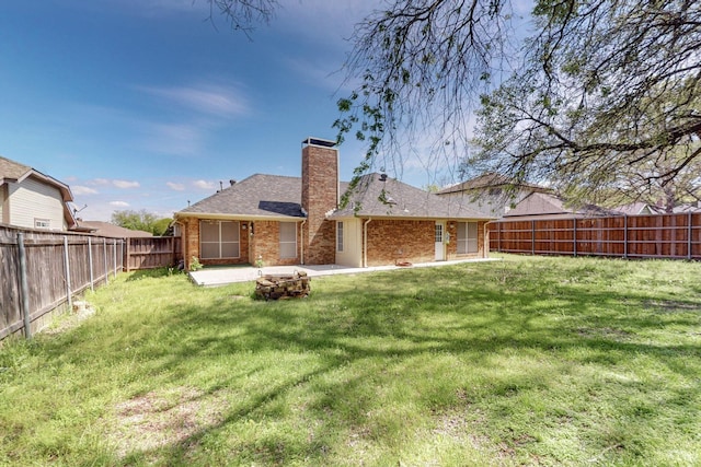 rear view of house with a patio area and a yard