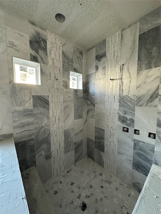 bathroom with a tile shower