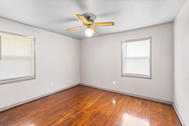 empty room with hardwood / wood-style flooring and ceiling fan