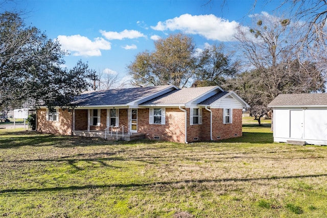 view of front of house with a shed, a porch, and a front lawn