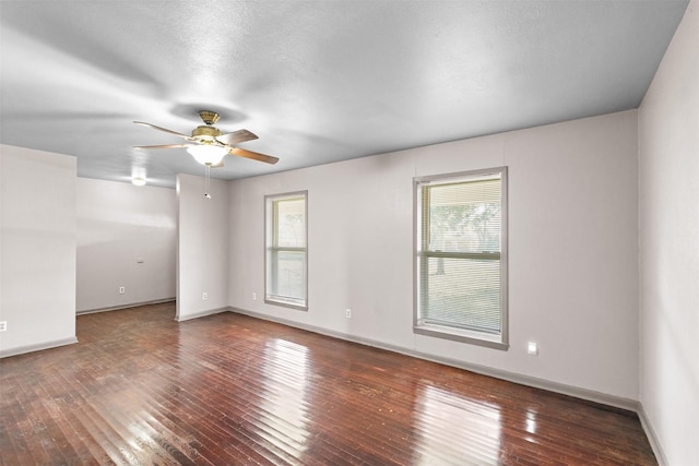 unfurnished room featuring ceiling fan, dark wood-type flooring, and a textured ceiling