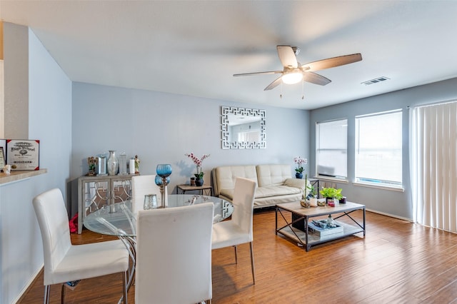 living room with wood-type flooring and ceiling fan