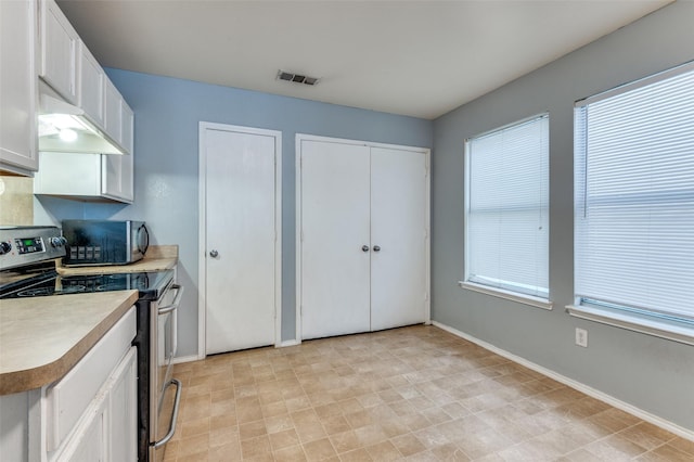 kitchen with white cabinetry and appliances with stainless steel finishes