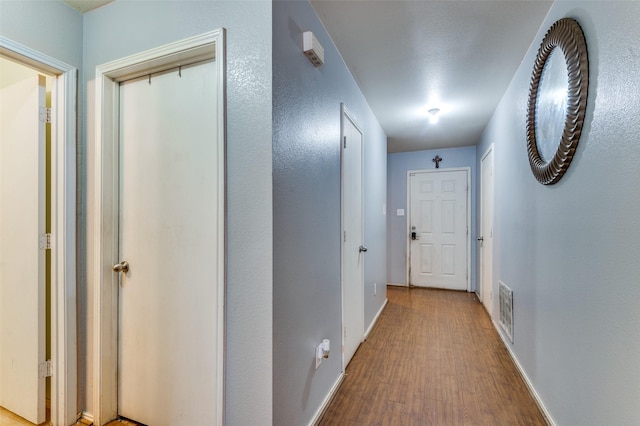 hall with hardwood / wood-style floors