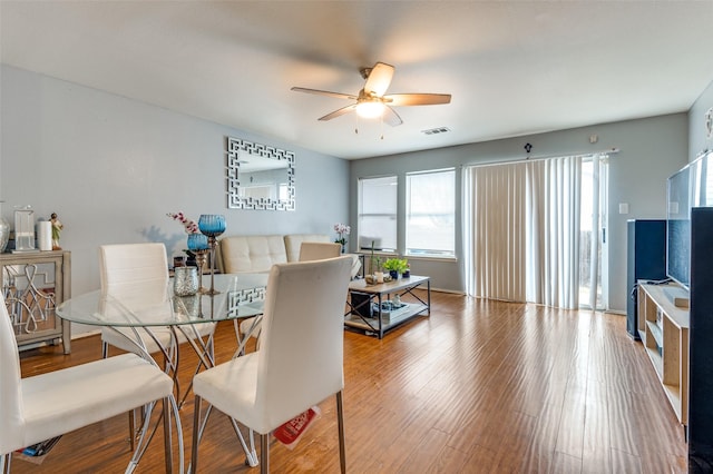 dining space with ceiling fan and hardwood / wood-style floors