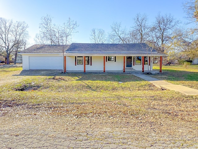 ranch-style home with a garage, a porch, and a front yard