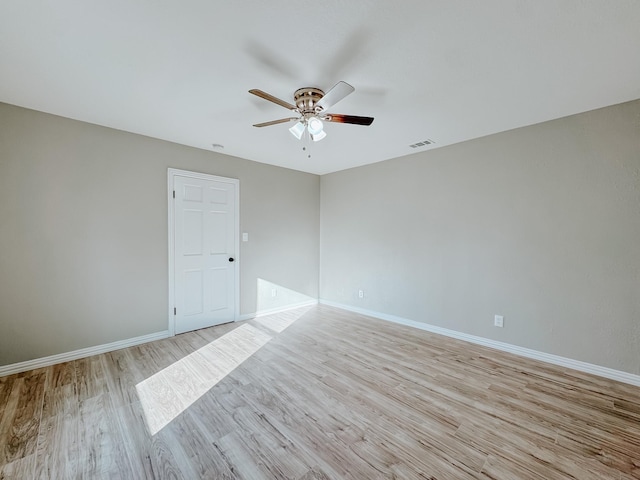 spare room featuring ceiling fan and light hardwood / wood-style floors