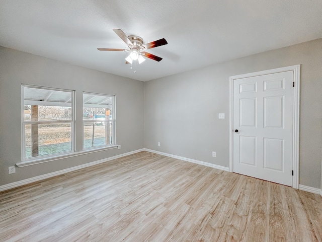 spare room featuring ceiling fan and light hardwood / wood-style flooring