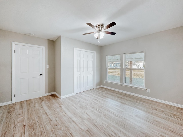 unfurnished bedroom with ceiling fan, light hardwood / wood-style floors, and a closet