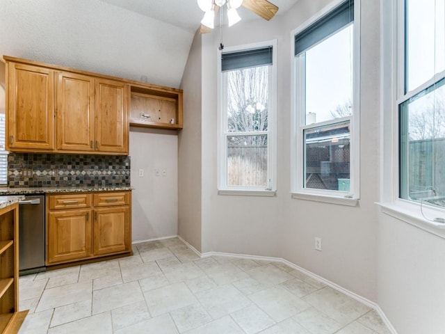 kitchen with ceiling fan, dishwasher, tasteful backsplash, light stone countertops, and vaulted ceiling