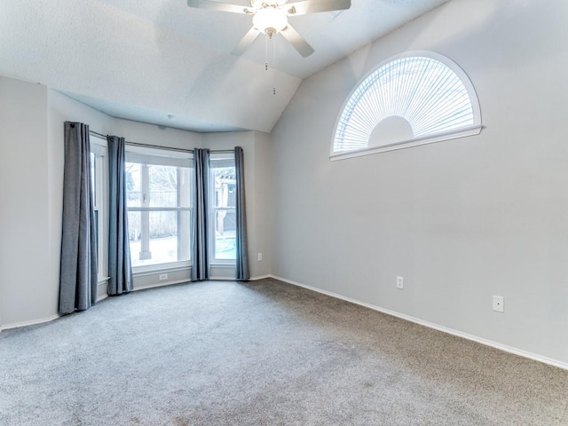 spare room with lofted ceiling, ceiling fan, and carpet flooring