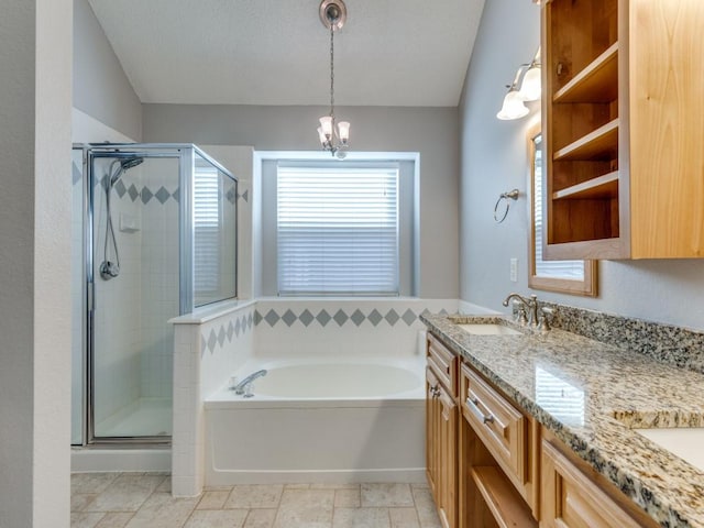 bathroom with vanity, vaulted ceiling, and independent shower and bath