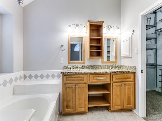 bathroom with vanity and a bath