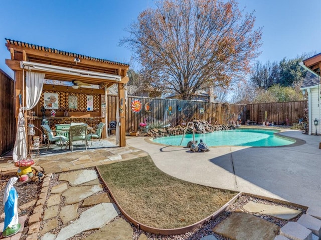 view of swimming pool featuring ceiling fan and a patio