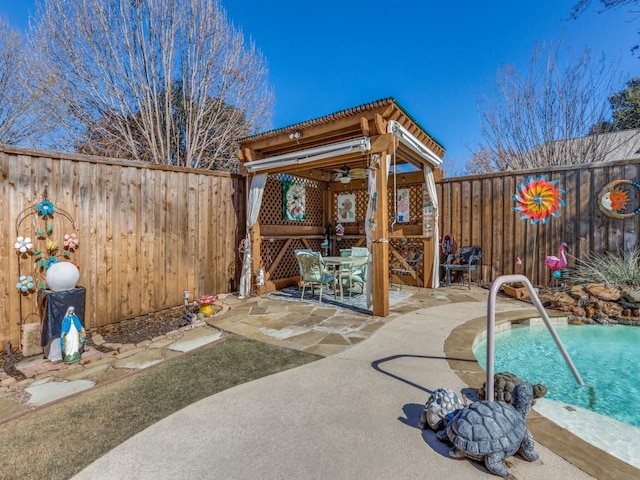 view of pool with ceiling fan and a patio area