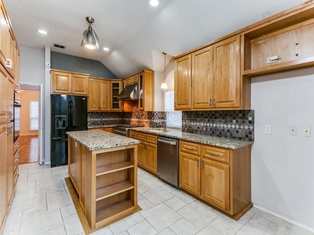 kitchen featuring pendant lighting, appliances with stainless steel finishes, a center island, tasteful backsplash, and light stone countertops