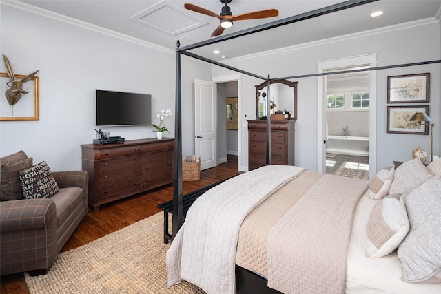 bedroom featuring crown molding, dark wood-type flooring, ensuite bath, and ceiling fan