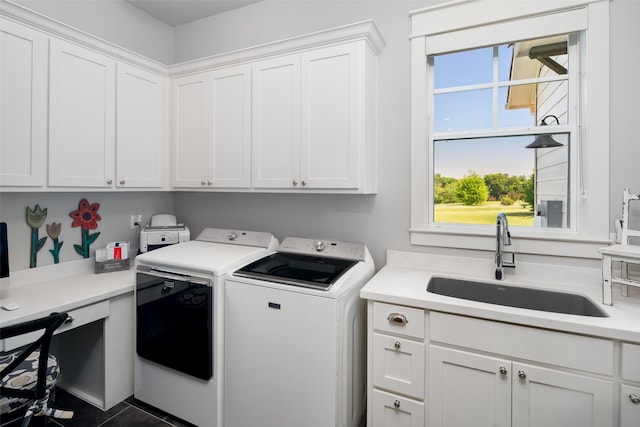 laundry area featuring sink, cabinets, washing machine and dryer, and dark tile patterned flooring