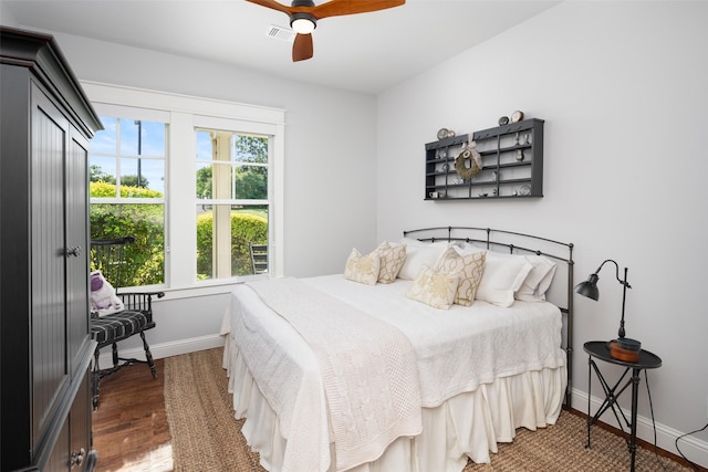 bedroom with ceiling fan and dark wood-type flooring