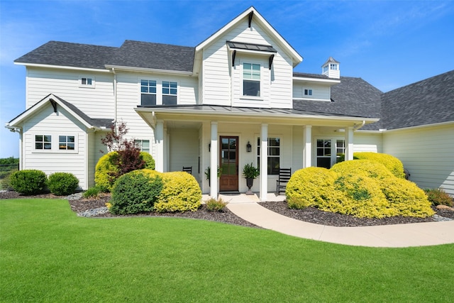 view of front of property with a porch and a front lawn