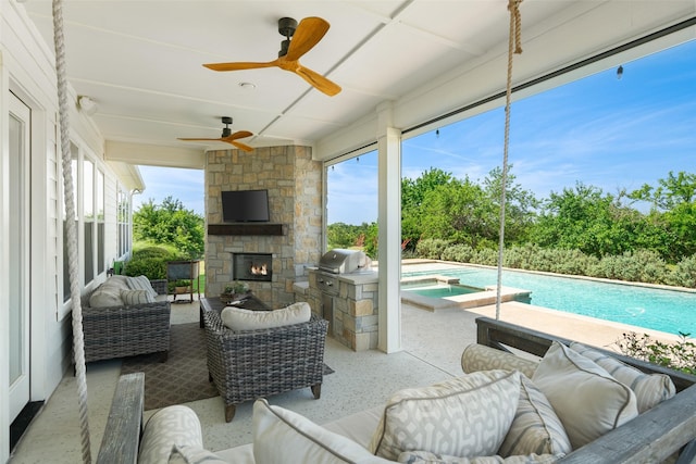 view of patio featuring area for grilling and an outdoor living space with a fireplace