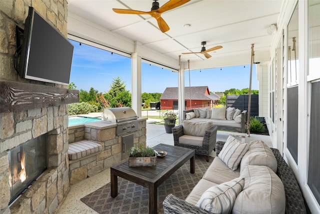 view of patio / terrace with exterior kitchen, grilling area, and an outdoor living space with a fireplace