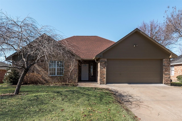 view of front of home with a front yard and a garage