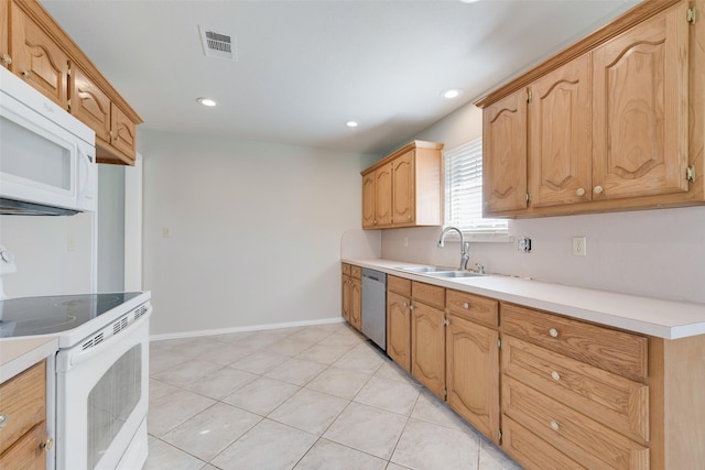 kitchen featuring sink, white appliances, and light tile patterned floors