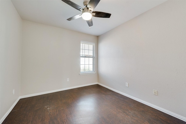 spare room with ceiling fan and dark hardwood / wood-style flooring