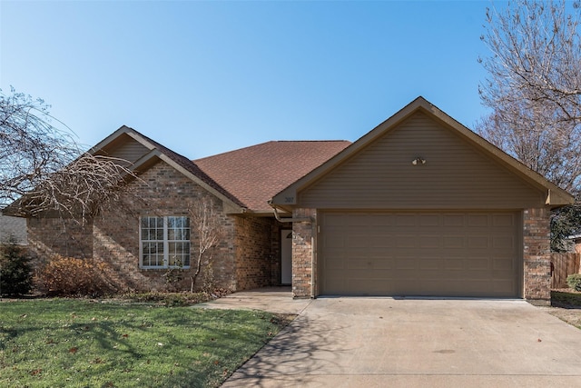 view of front of home featuring a garage and a front yard