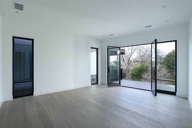 spare room with light hardwood / wood-style floors