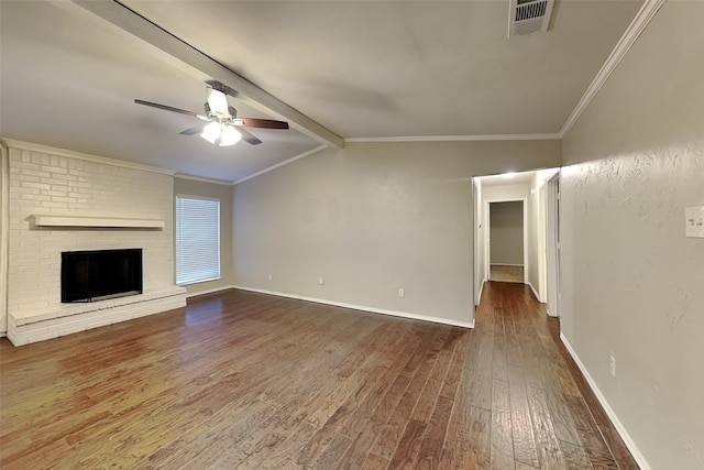 unfurnished living room with crown molding, ceiling fan, hardwood / wood-style flooring, lofted ceiling with beams, and a brick fireplace