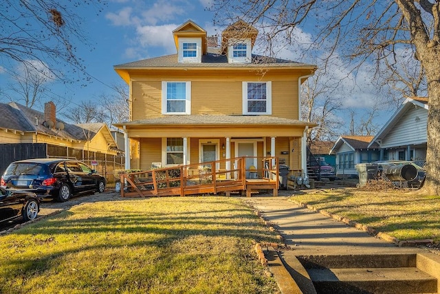 view of front of house with covered porch and a front lawn