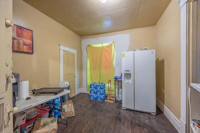 kitchen with white refrigerator with ice dispenser and dark wood-type flooring