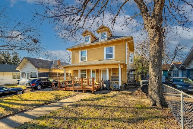 view of front of house with a front lawn and a porch