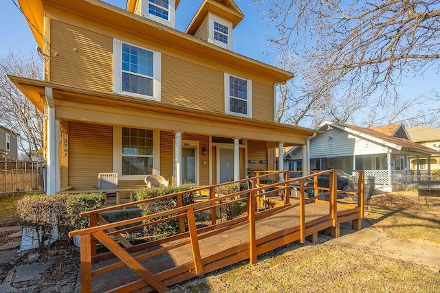 back of property featuring covered porch