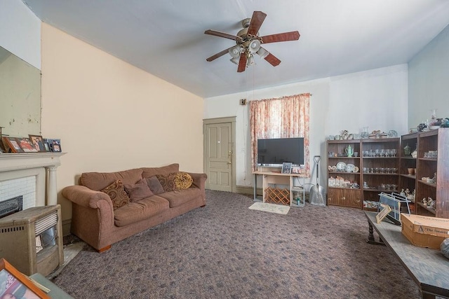 living room featuring carpet floors, ceiling fan, and a fireplace