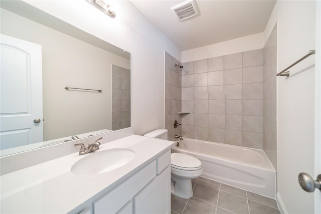 full bathroom featuring tile patterned flooring, vanity, toilet, and tiled shower / bath