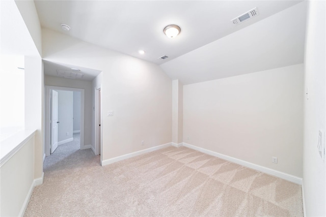 carpeted spare room featuring lofted ceiling