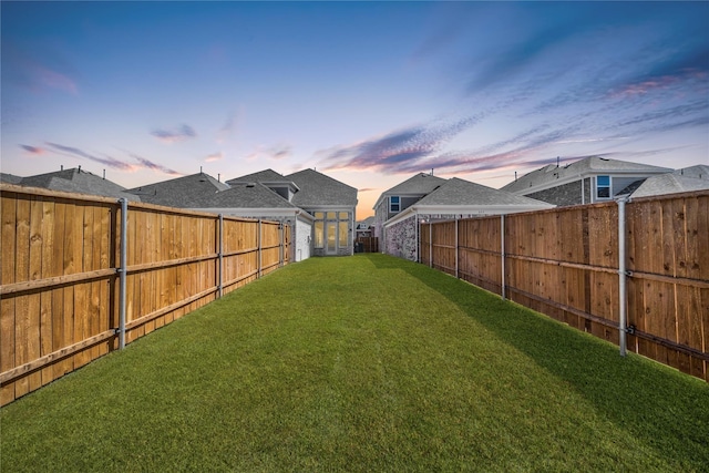 view of yard at dusk