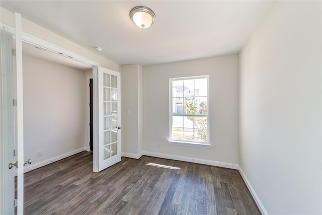 unfurnished bedroom featuring french doors and dark hardwood / wood-style floors