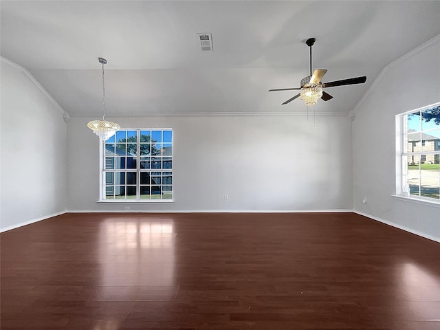 entryway featuring ceiling fan with notable chandelier, dark hardwood / wood-style floors, vaulted ceiling, and ornamental molding