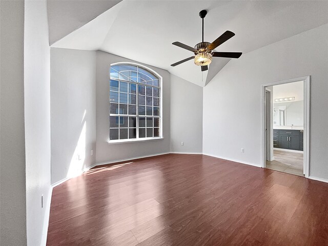 spare room with ornamental molding, ceiling fan with notable chandelier, lofted ceiling, and dark hardwood / wood-style flooring