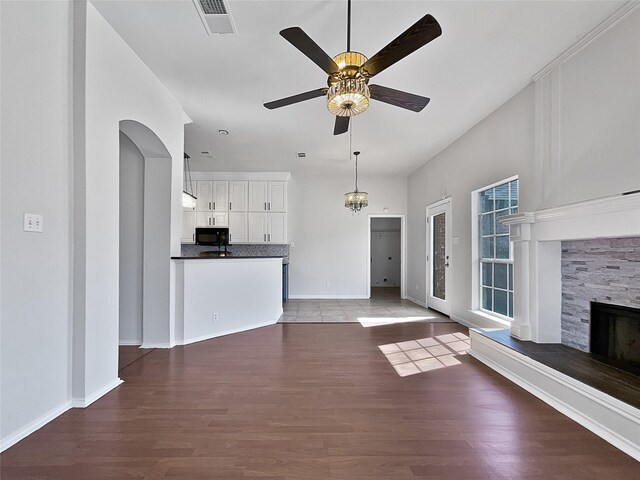 empty room with ceiling fan, hardwood / wood-style flooring, and lofted ceiling