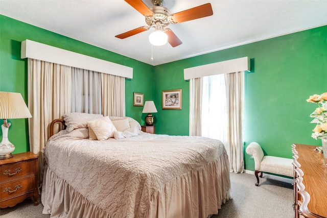 bedroom with ceiling fan and light colored carpet