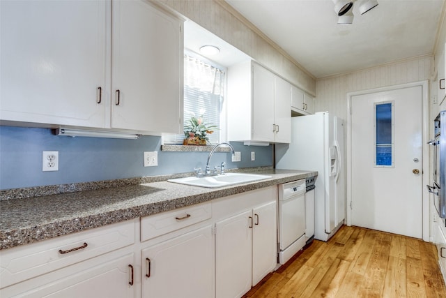 kitchen featuring sink, light wood-type flooring, white cabinetry, and white appliances