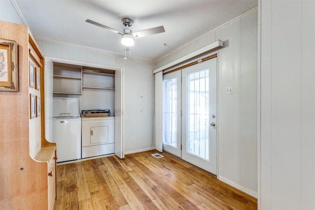 doorway featuring ceiling fan, separate washer and dryer, light hardwood / wood-style flooring, and crown molding